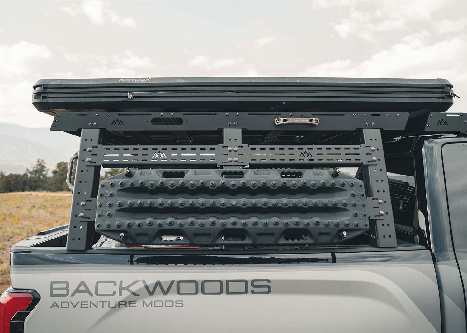 Backwoods Adventure Mods Bed Rack DRIFTR Topper cargo carrier installed on  a 2022+ 3rd Gen Toyota Tundra bed rack with a roof top tent mounted on top