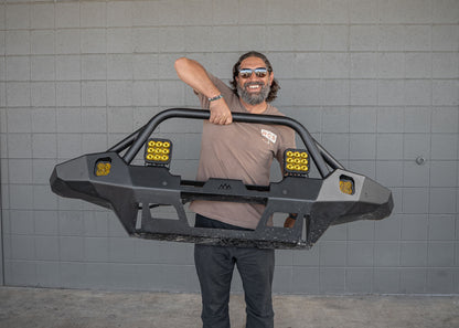 Man lifting the 2024 4th Gen Toyota Tacoma Backwoods Adventure Mods Hi-Lite Overland hybrid aluminum high clearance Front Bumper with Prerunner Bull Bar with one hand