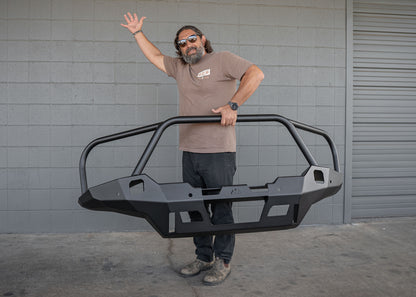 Man lifting the Backwoods Adventure Mods Toyota Tacoma 4th Gen (2024) Hi-Lite Front Bull Bar Bumper with one hand