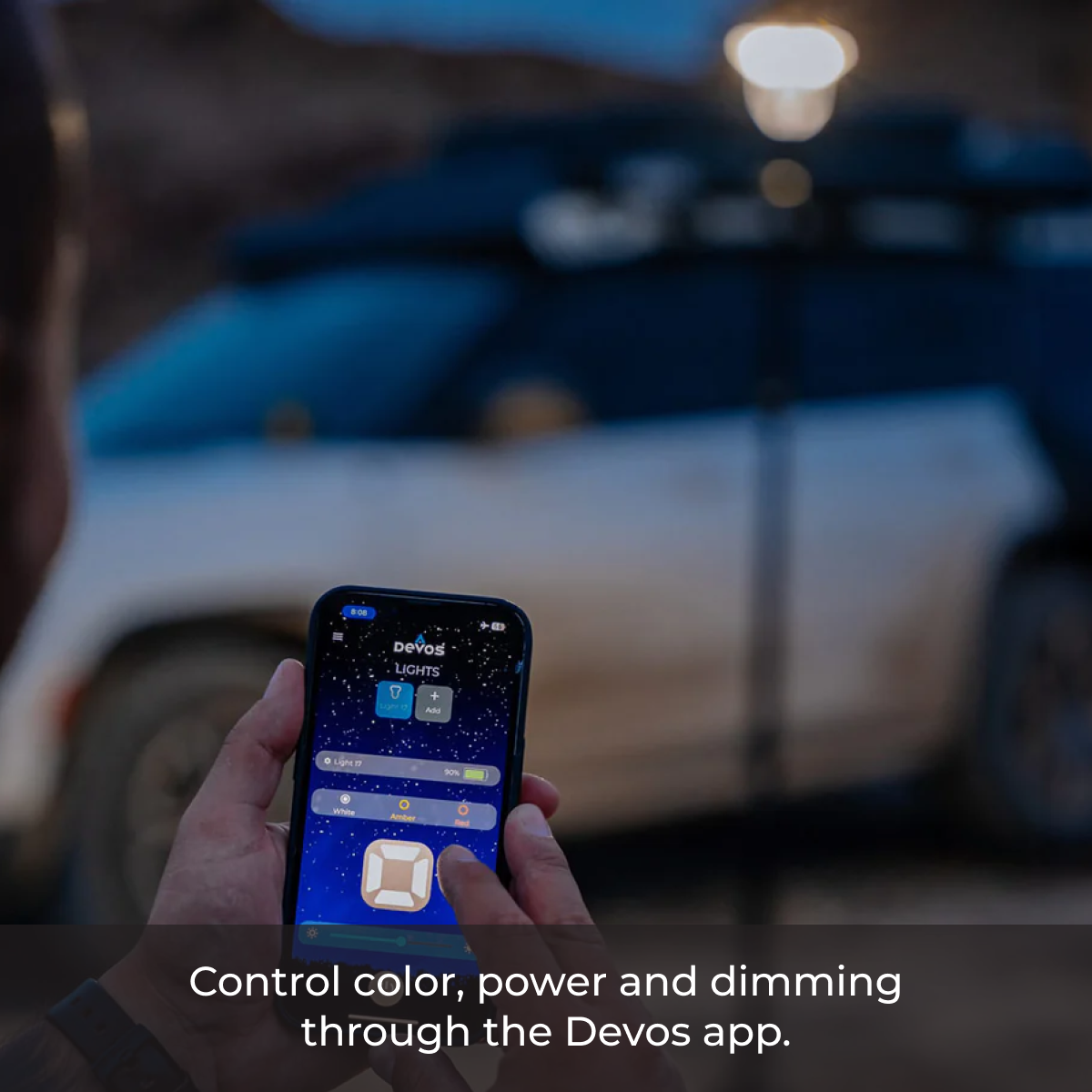 Using the Devos app to adjust LightRanger 2000 lighting settings outdoors—control color, brightness, and power with your phone.