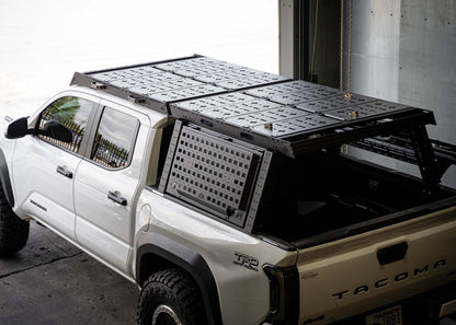 Backwoods Adventure Mods Bed Rack DRIFTR Topper cargo carrier add-on installed on a 3rd Gen Toyota Tacoma Overland truck bed rack with optional storage accessories