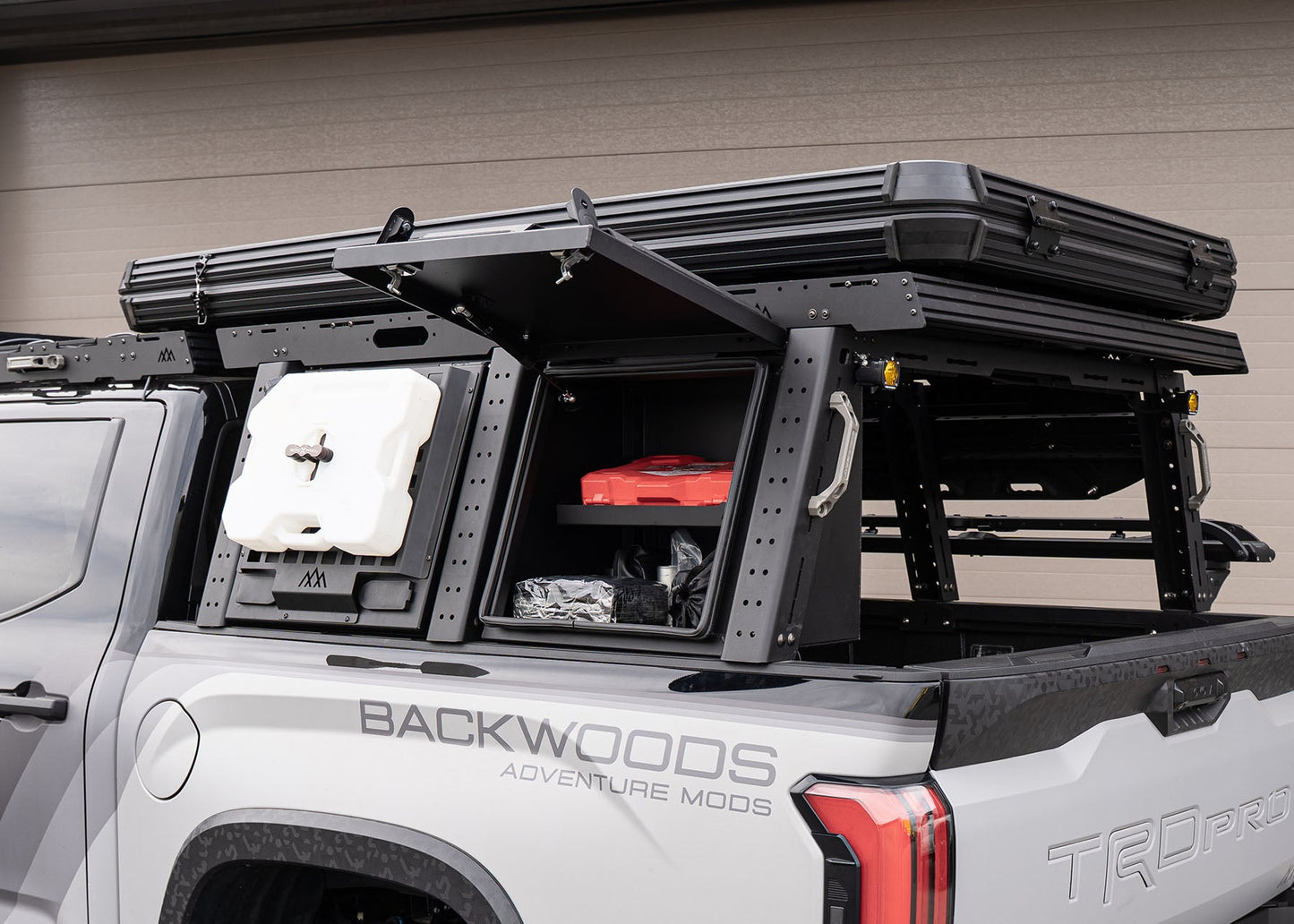 Front of the Backwoods Adventure Mods Toyota Tundra Aluminum Bed Rack Storage Box with lid open